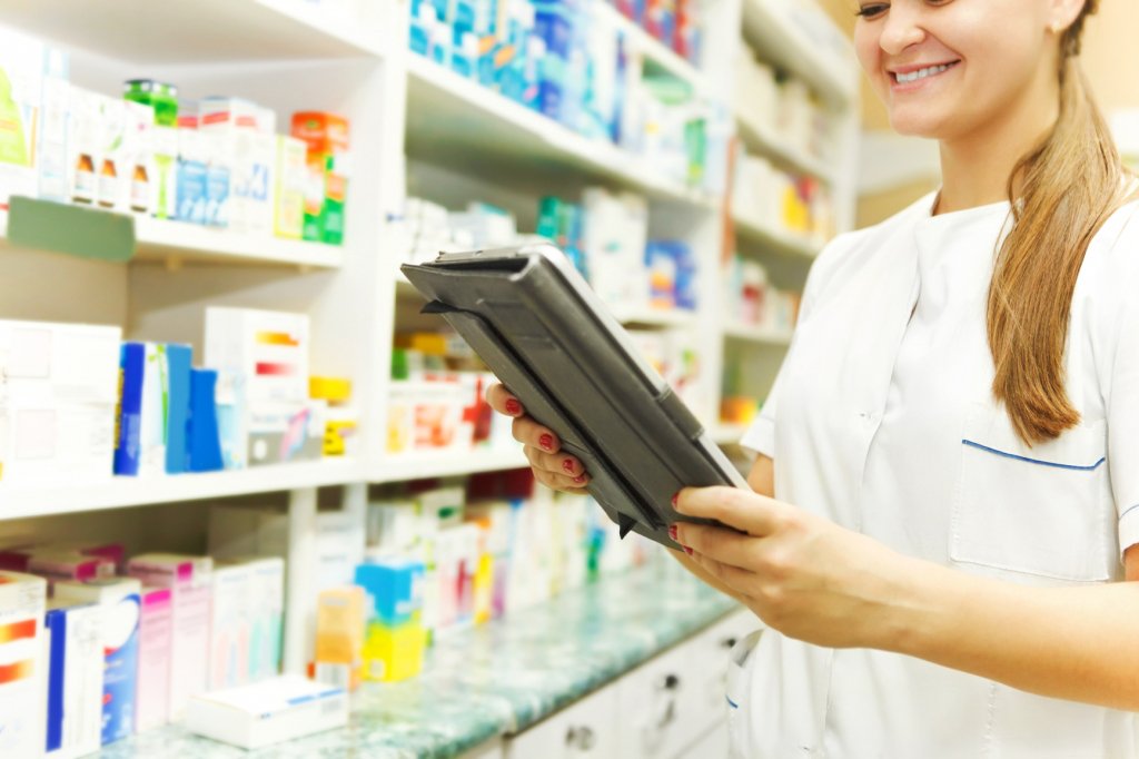 woman looking at pharmacy shelves