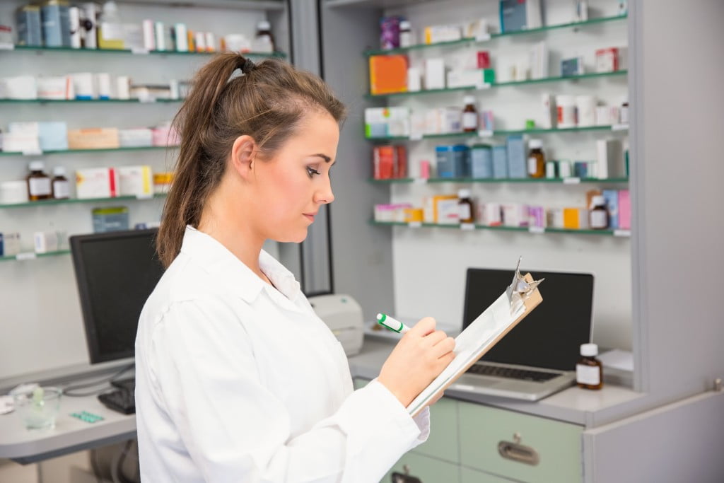 woman pharmacist writing on a piece of paper