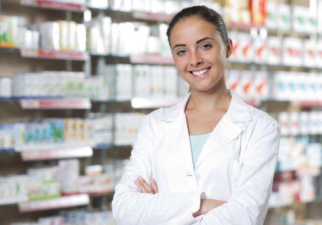 happy pharmacist smiling in dispensary