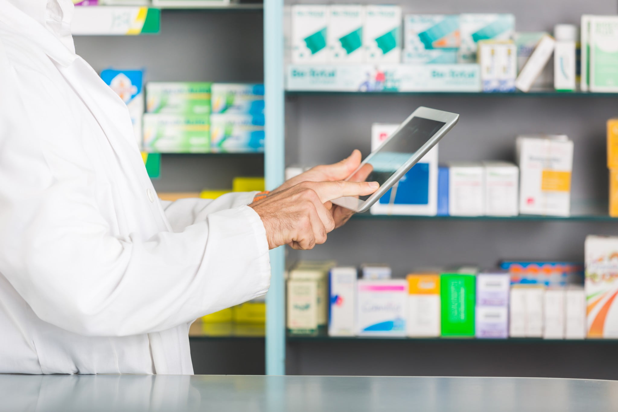 pharmacist with tablet in store
