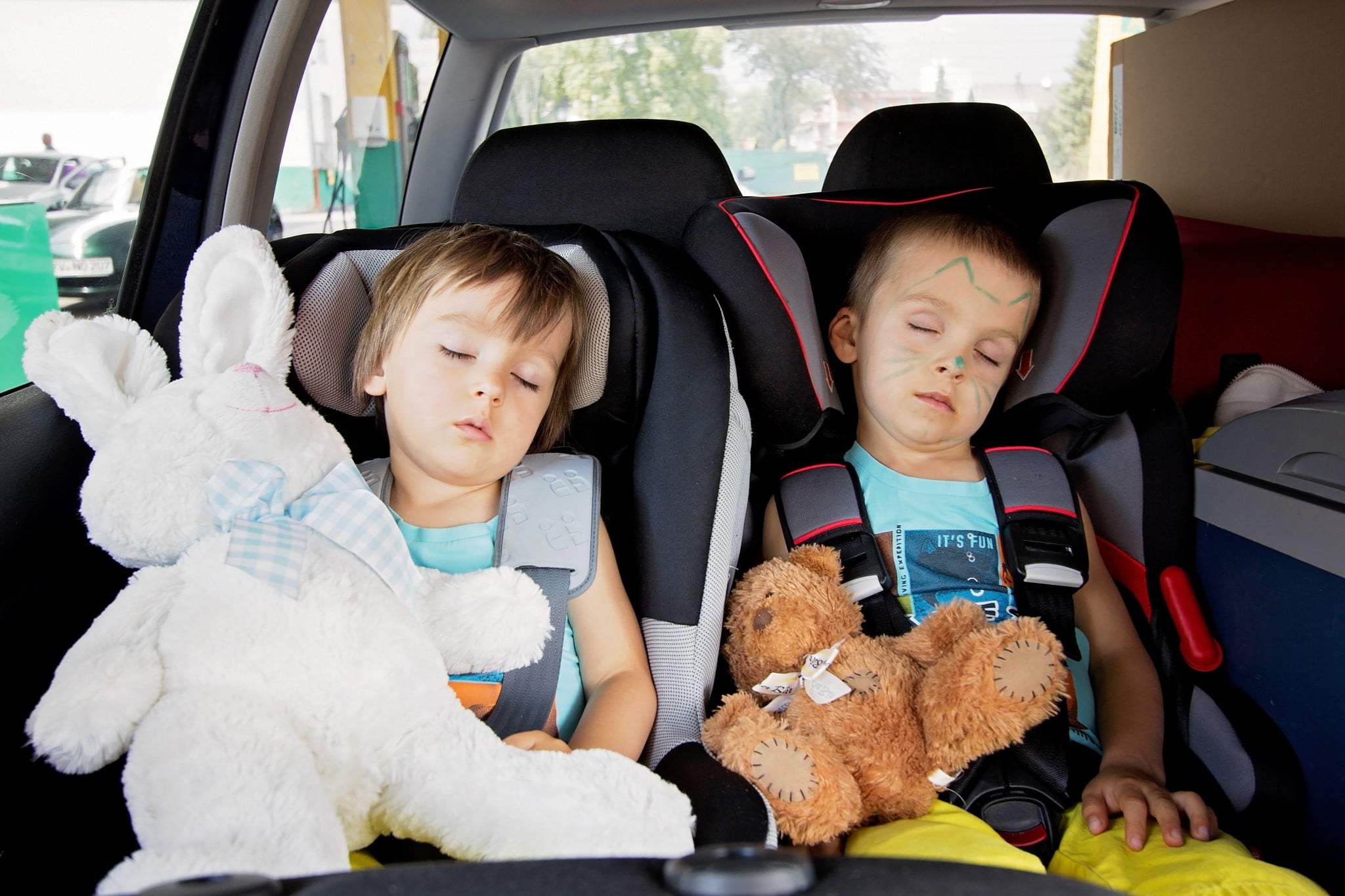 sedating antihistamines: two boys asleep in the back seat of a car
