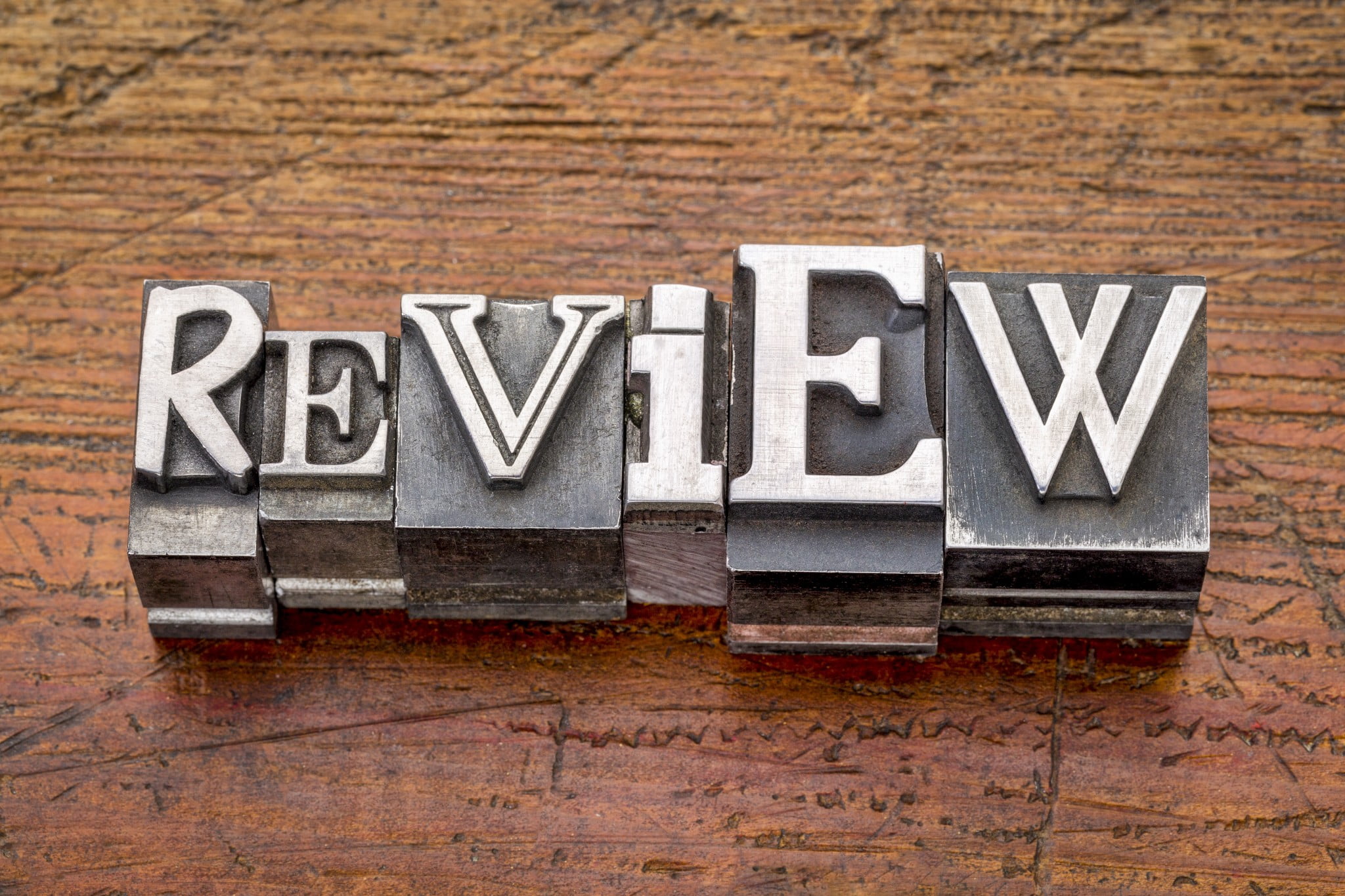 Word "review" in metal type