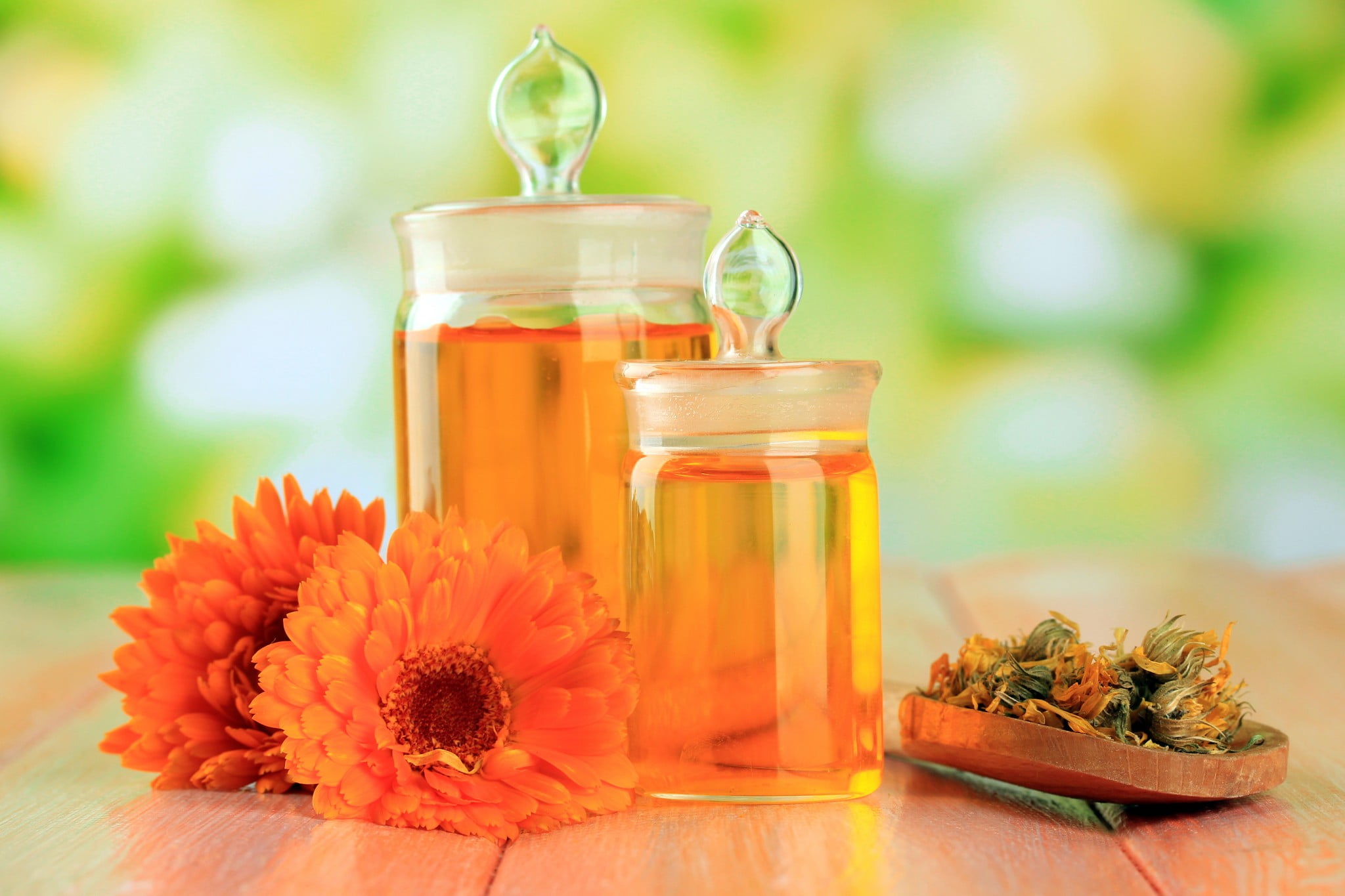 homoepathy: jars full of tincture and some orange flowers