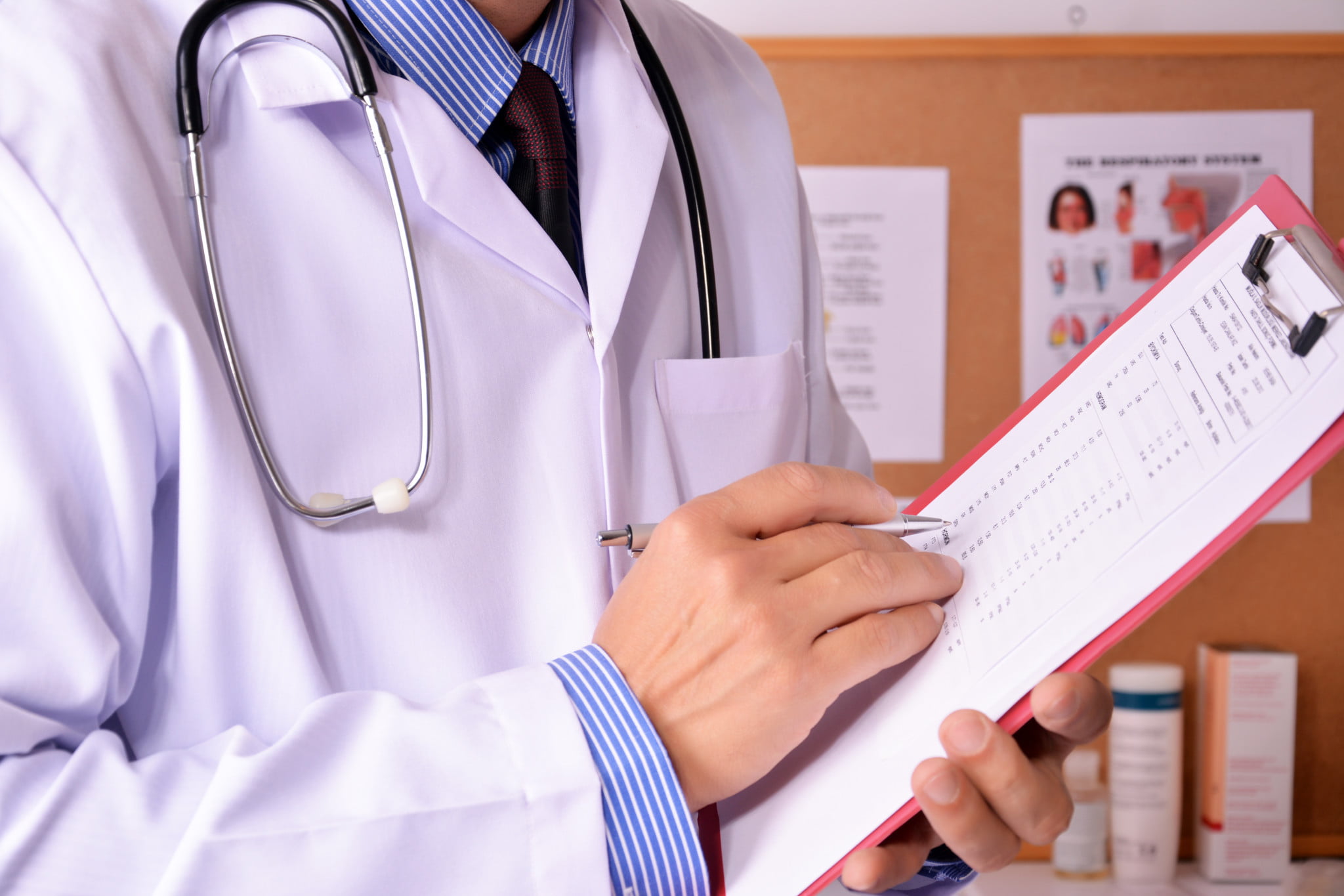 choosing wisely: doctor writes on clipboard