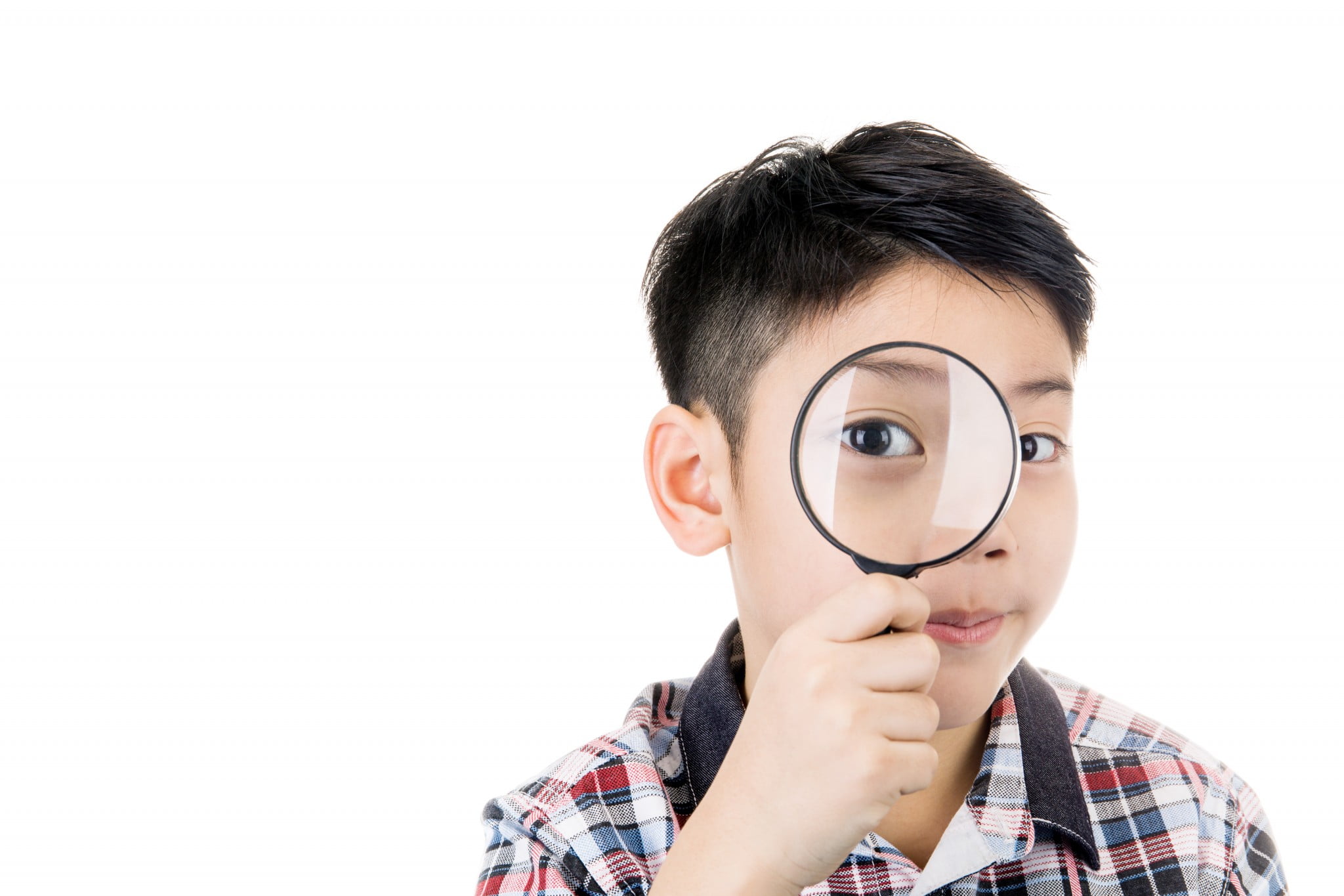 Myopia: little boy looks through magnifying glass
