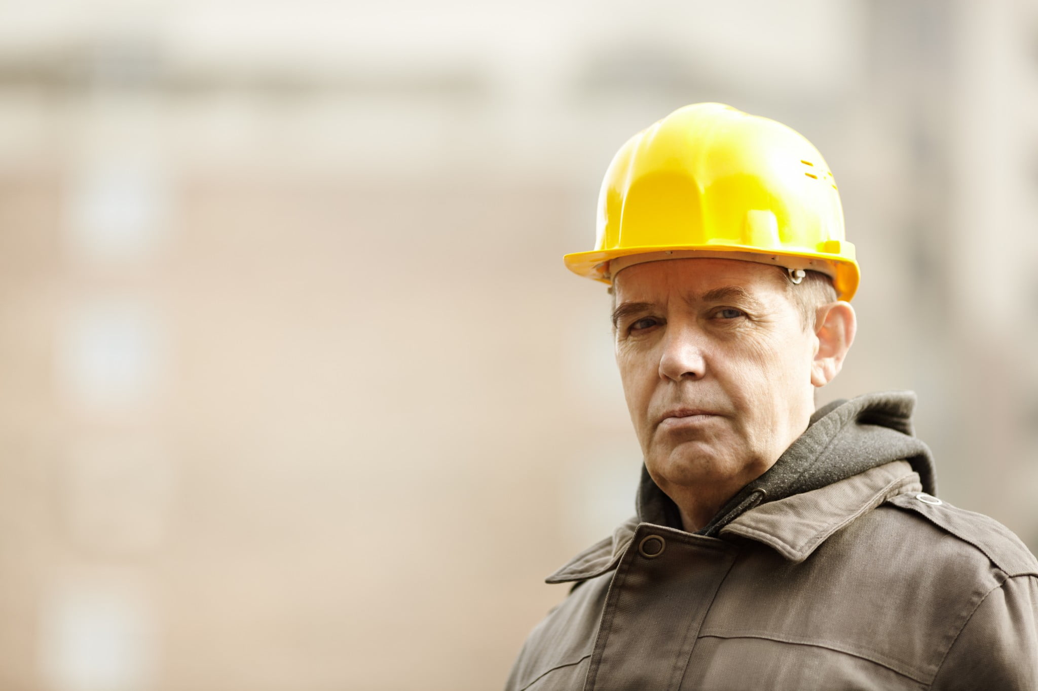 FIFO workers doubled risk of depression: older man in yellow hard hat looking wistful