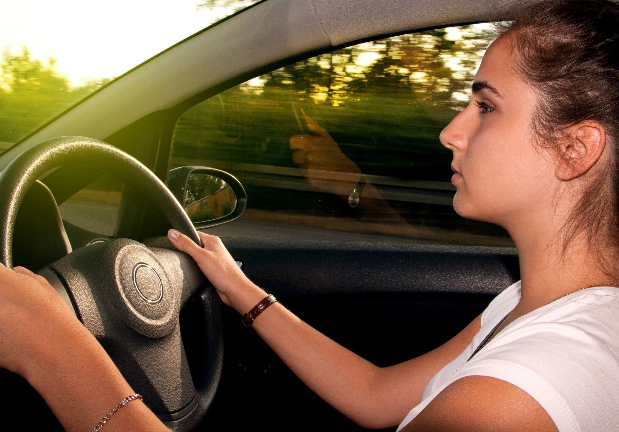 sleep guidelines: teenage girl behind the wheel looking nervous