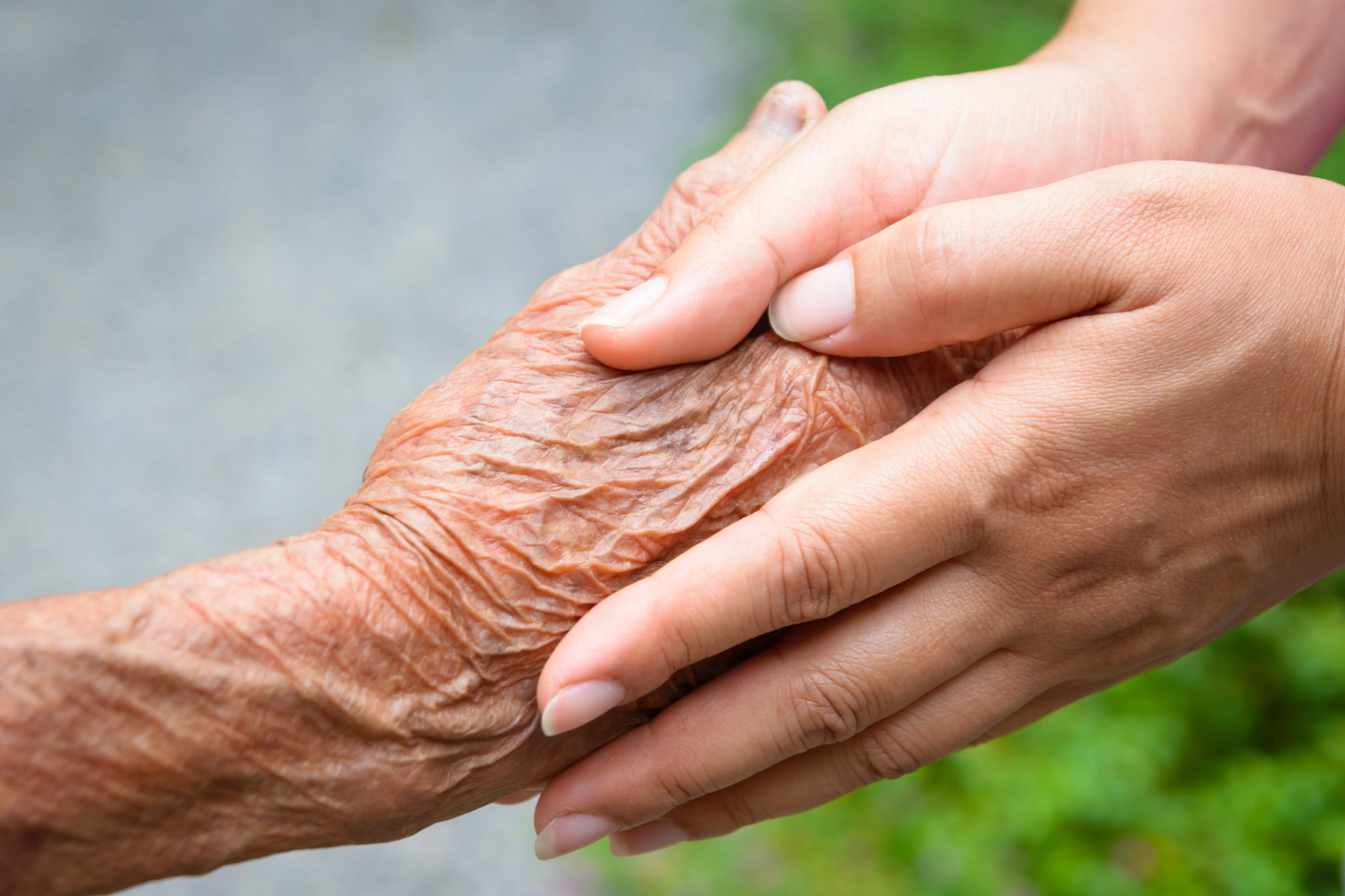 dementia-friendly communities: older hand held by younger hands