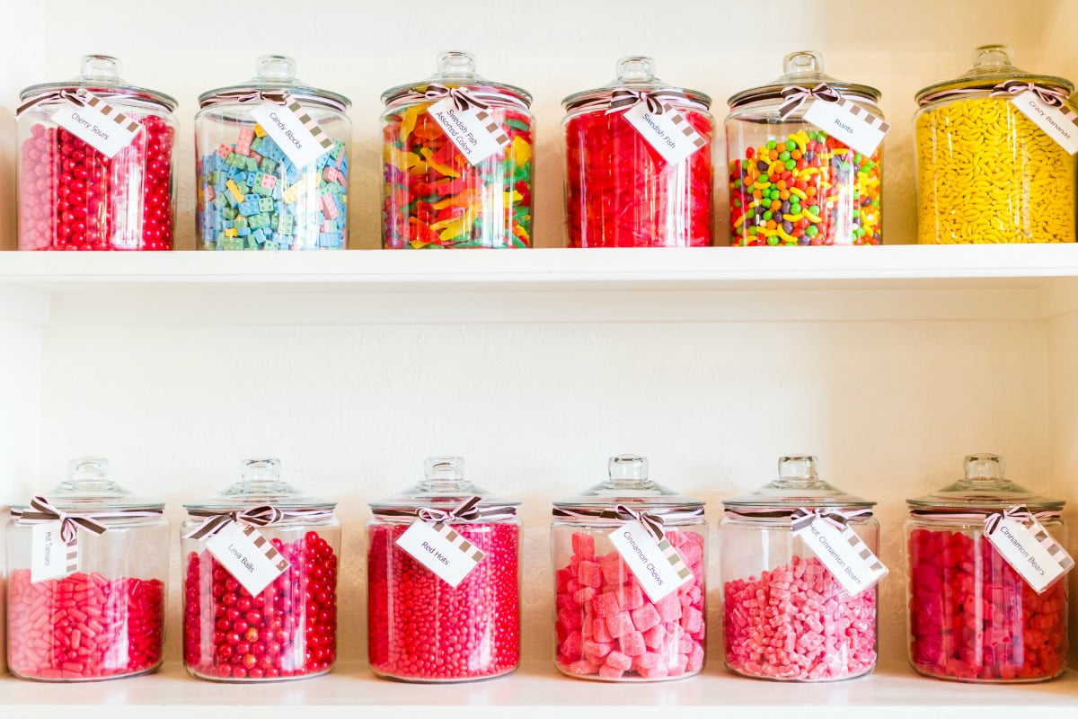 treats: lots of lollies, mostly pink, in candy jars on shelf