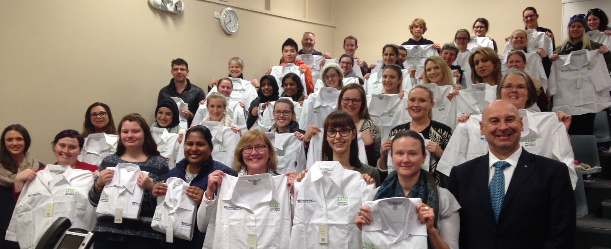 UNE's new pharmacy students show off their white shirts