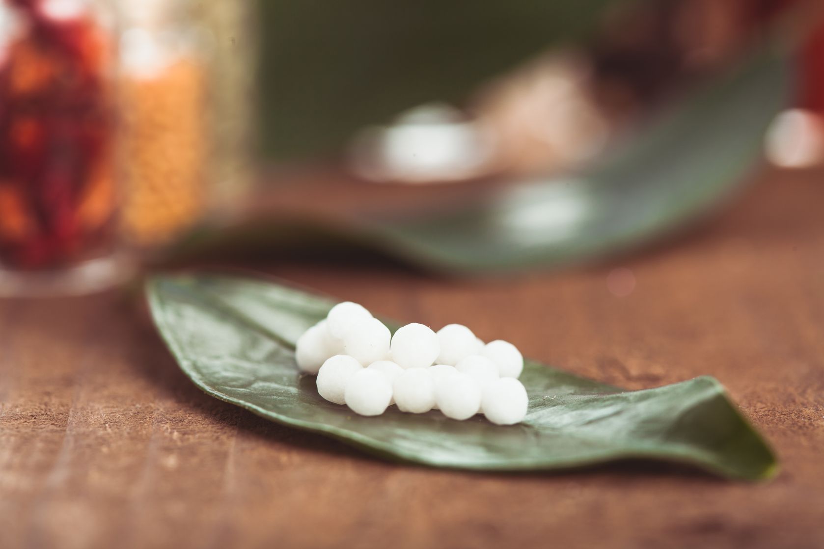 homeopathy round white pills on leaf
