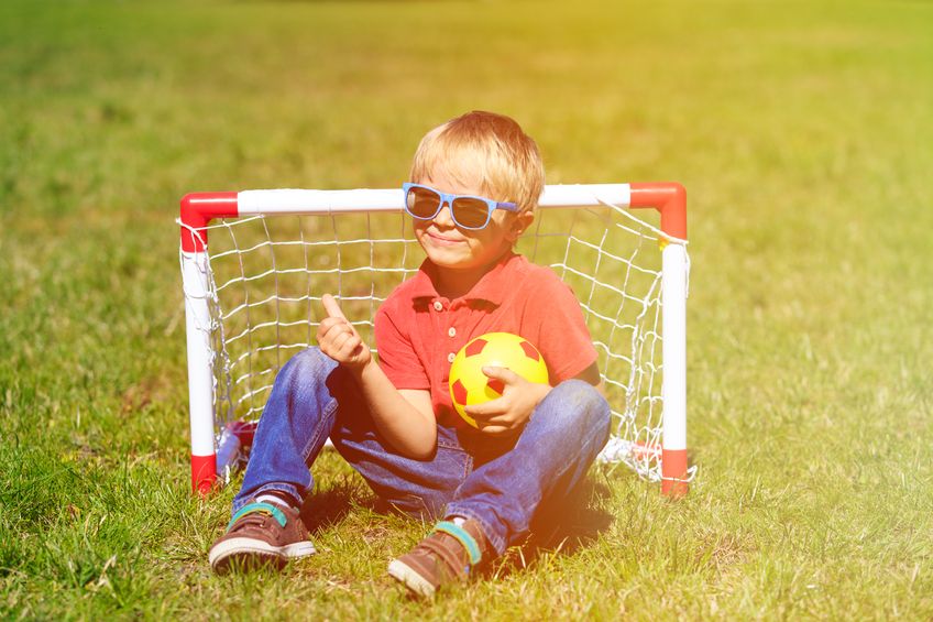little boy playing mini soccer