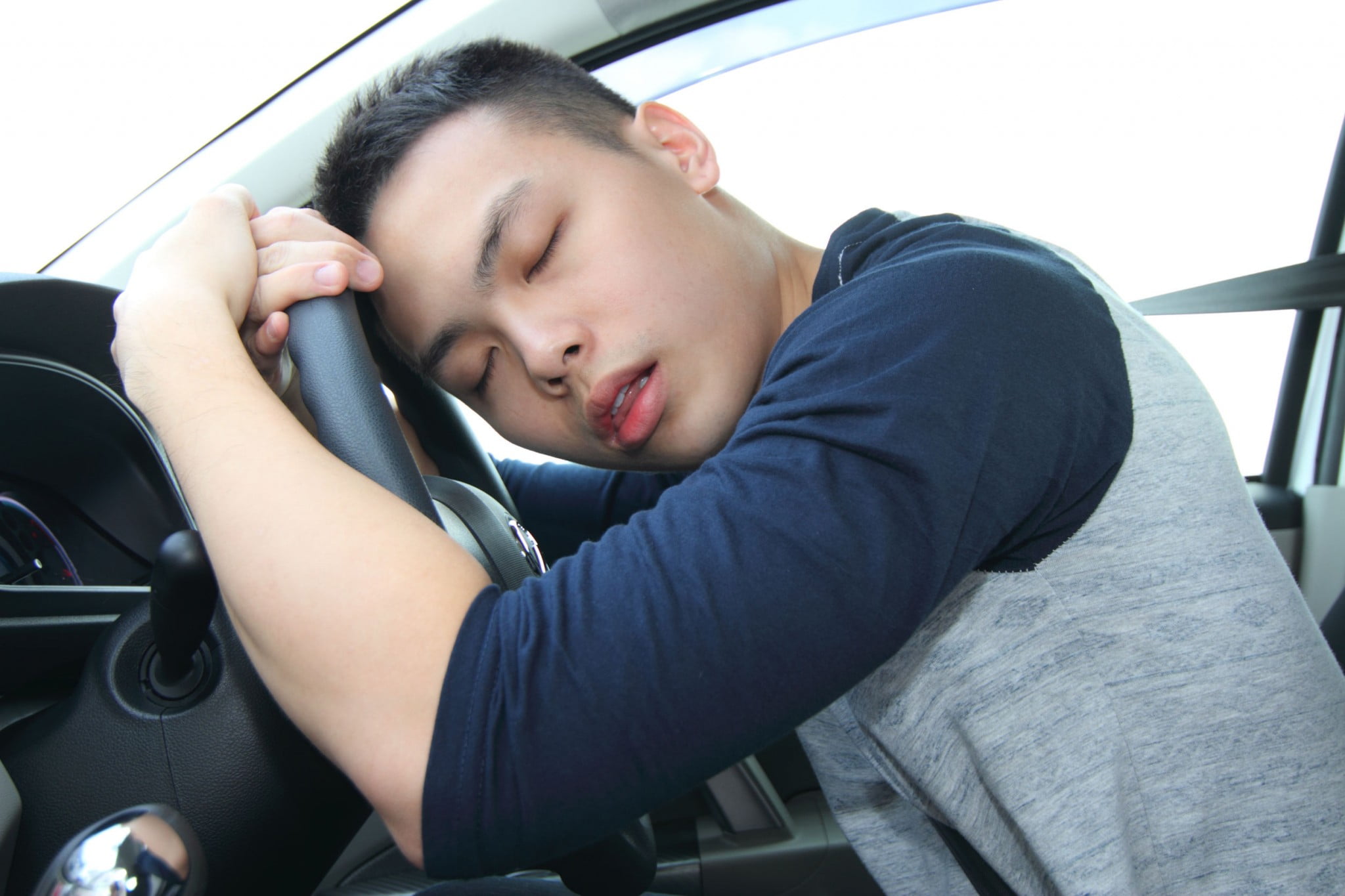 man who has fallen asleep at the wheel