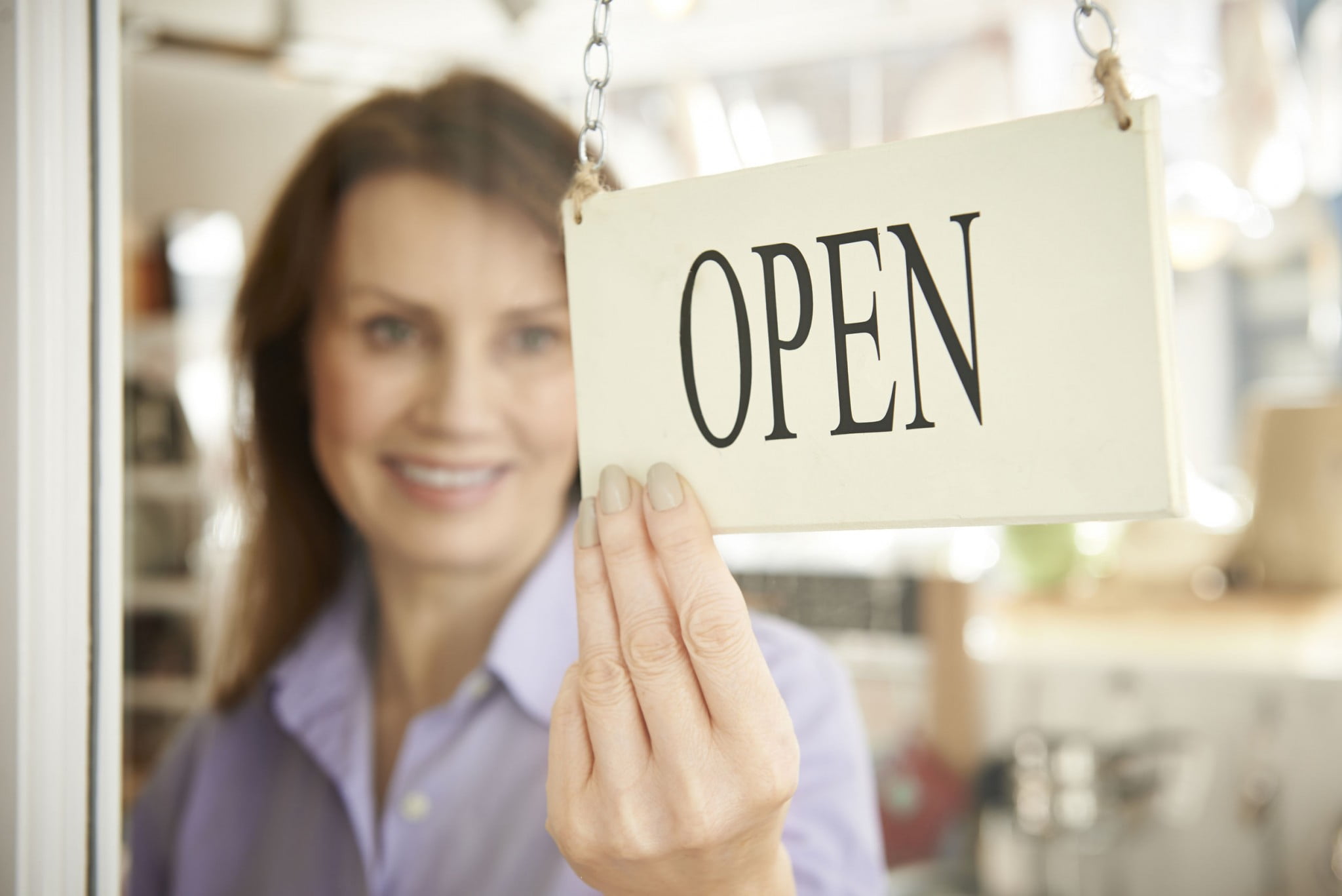 Shop with "open" sign at door - business confidence