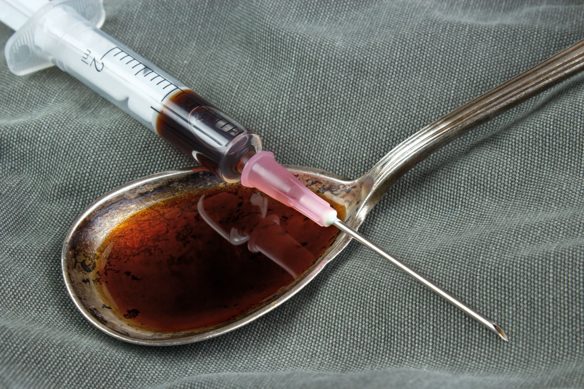 heroin on spoon and syringe for naloxone stories