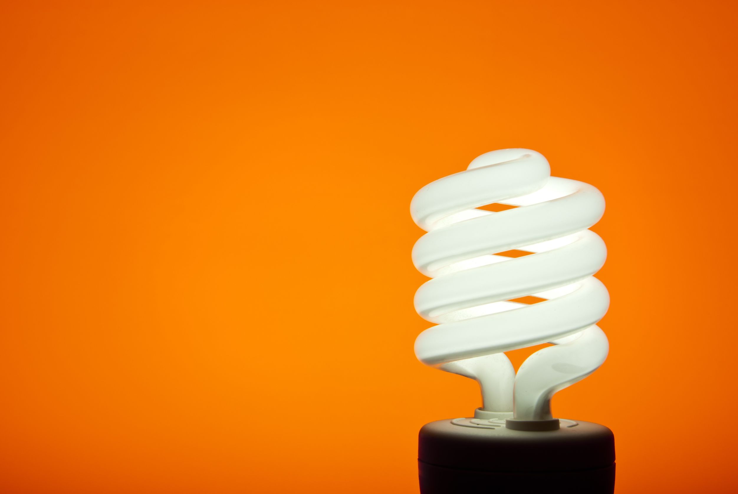 smart light bulb on orange background