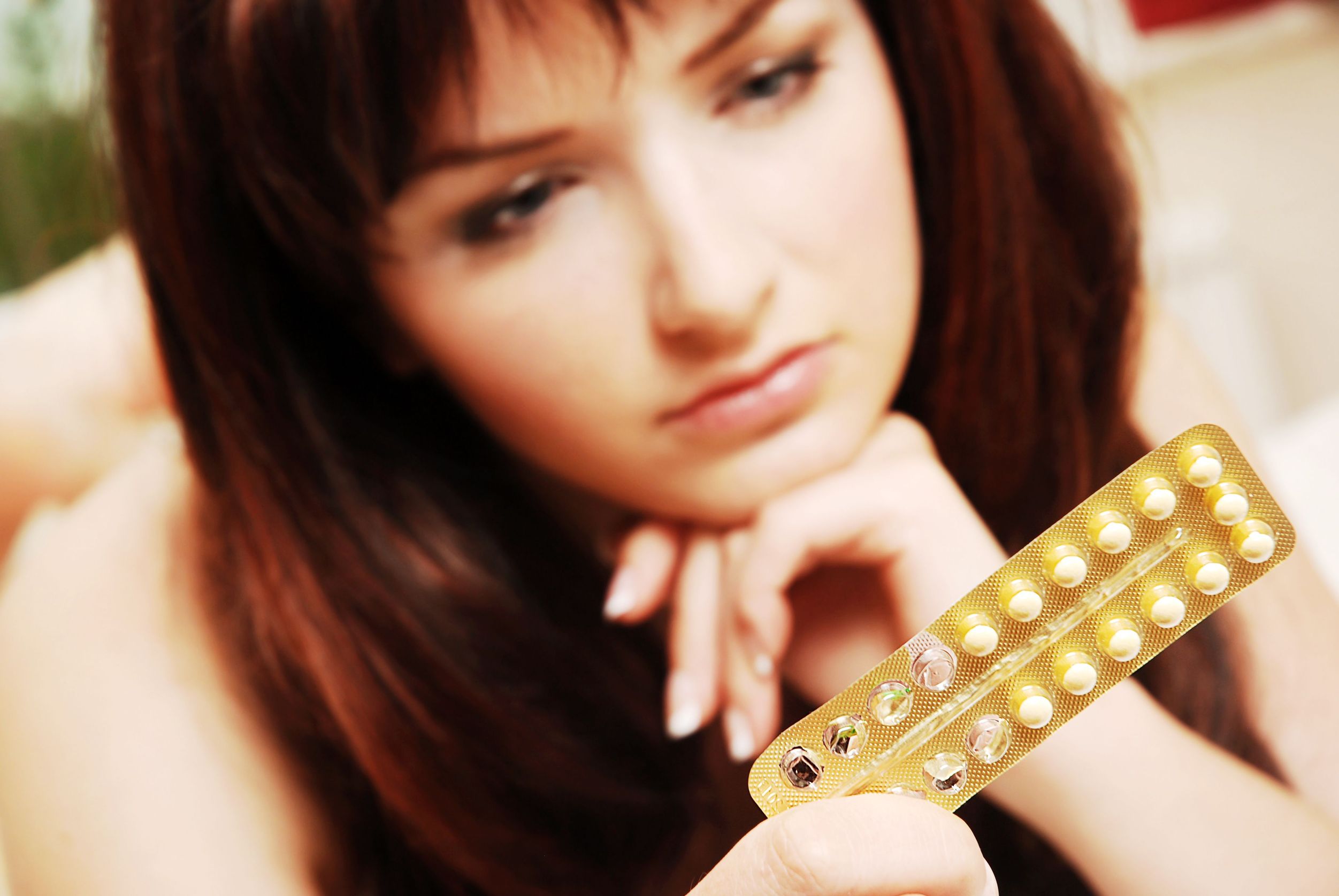 woman looking at birth control