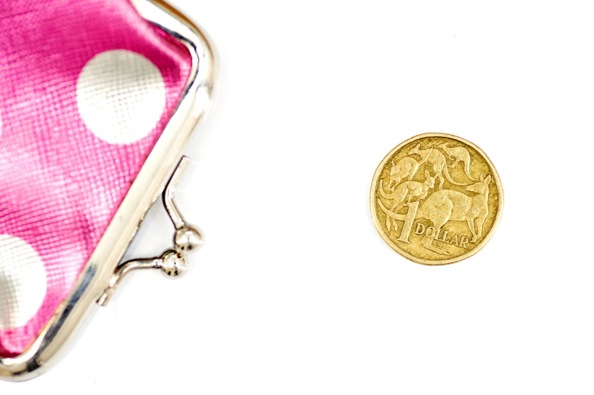 $1 coin and pink coin purse