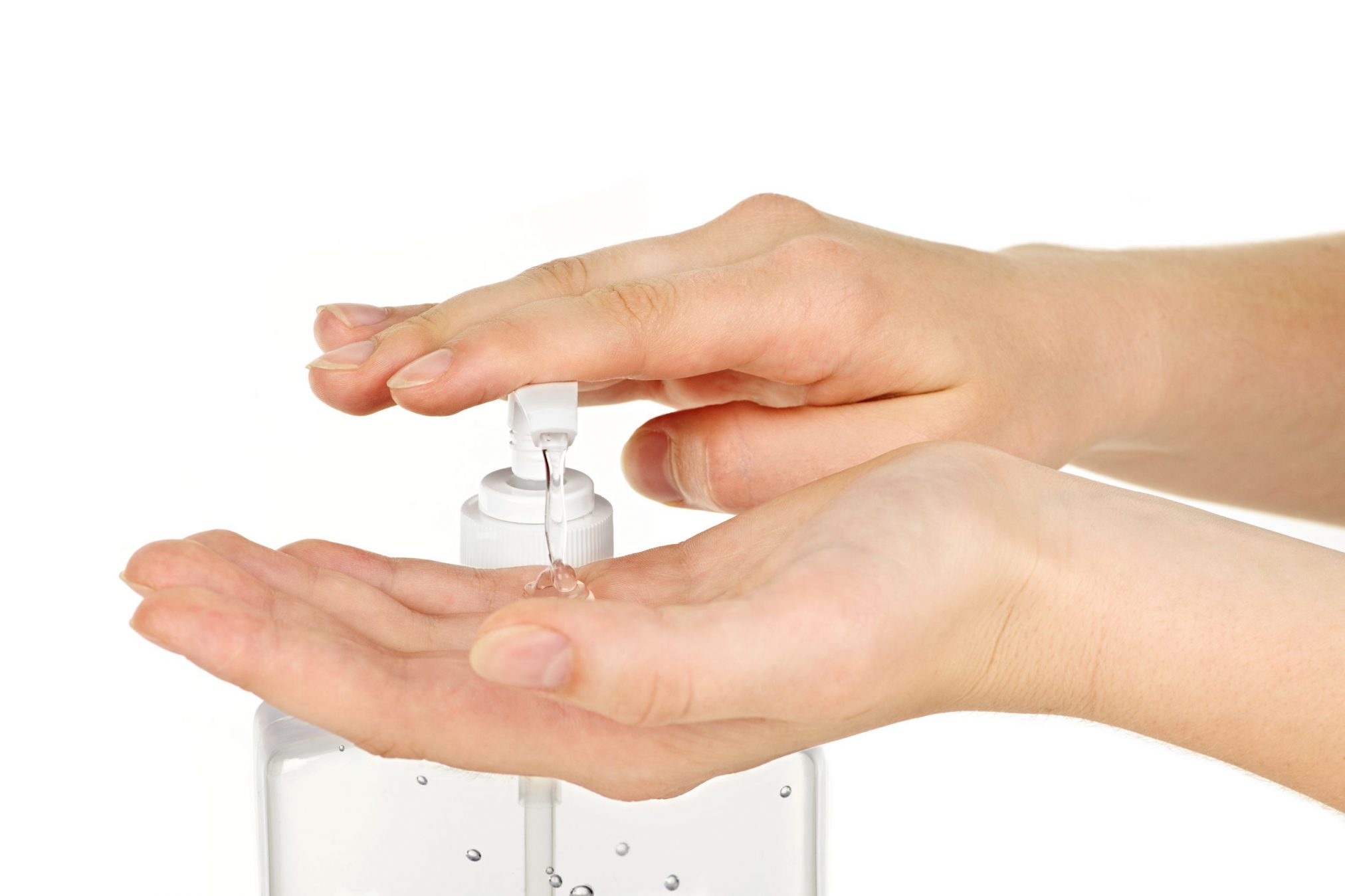 female hands using hand sanitizer gel pump