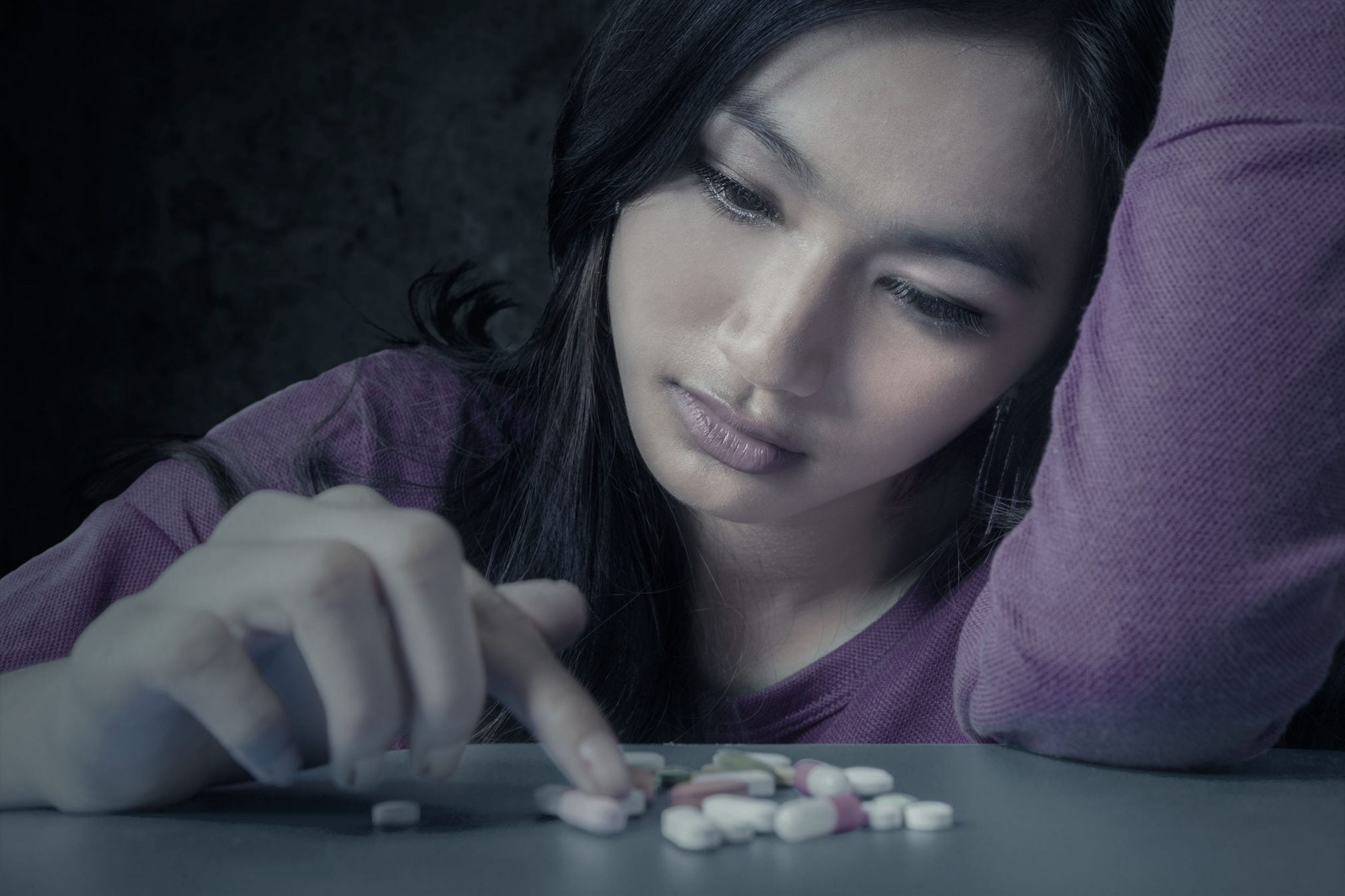 sad woman with pills