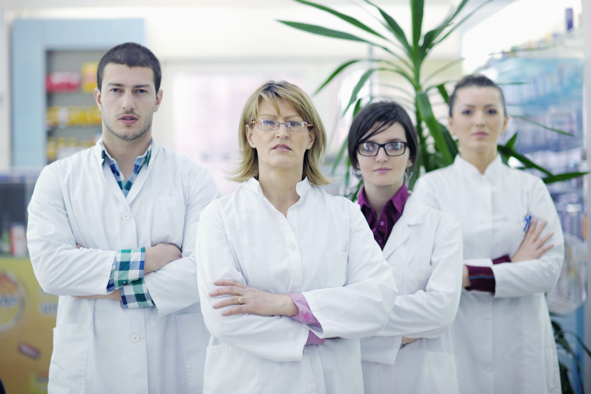 four unfriendly-looking pharmacists