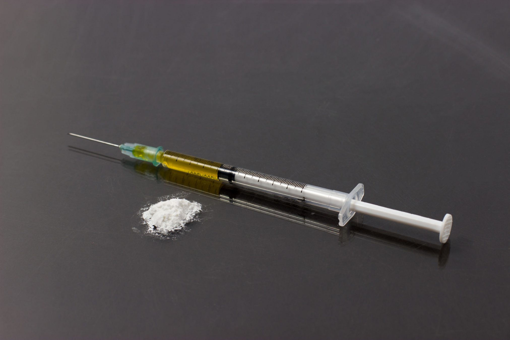 Heroin in a syringe and powder