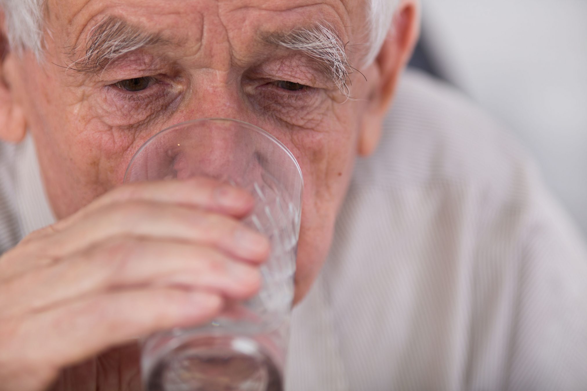 elderly man drinking