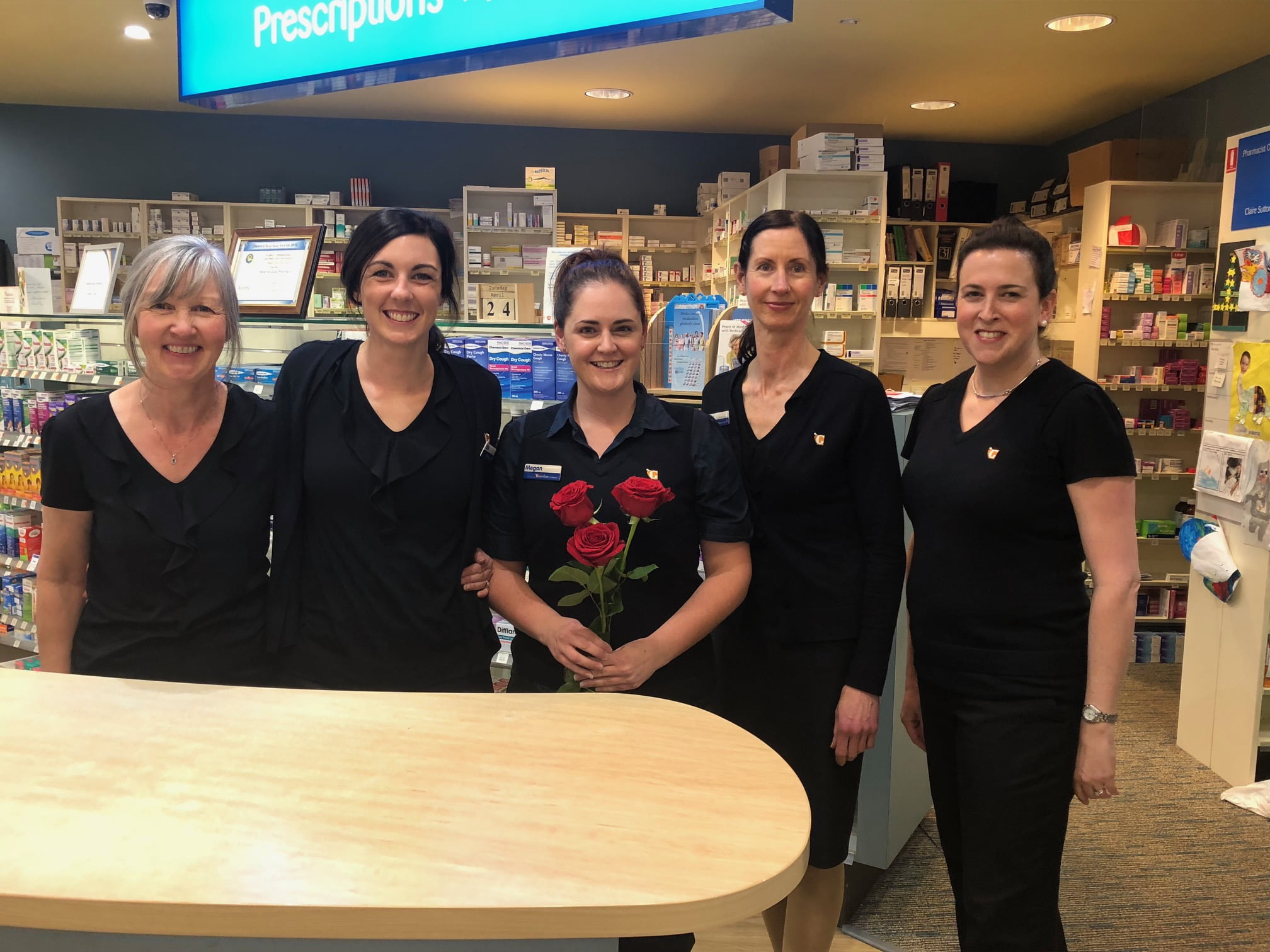 Bellerive Quay Guardian pharmacy donated to 65 Roses. Staff with roses