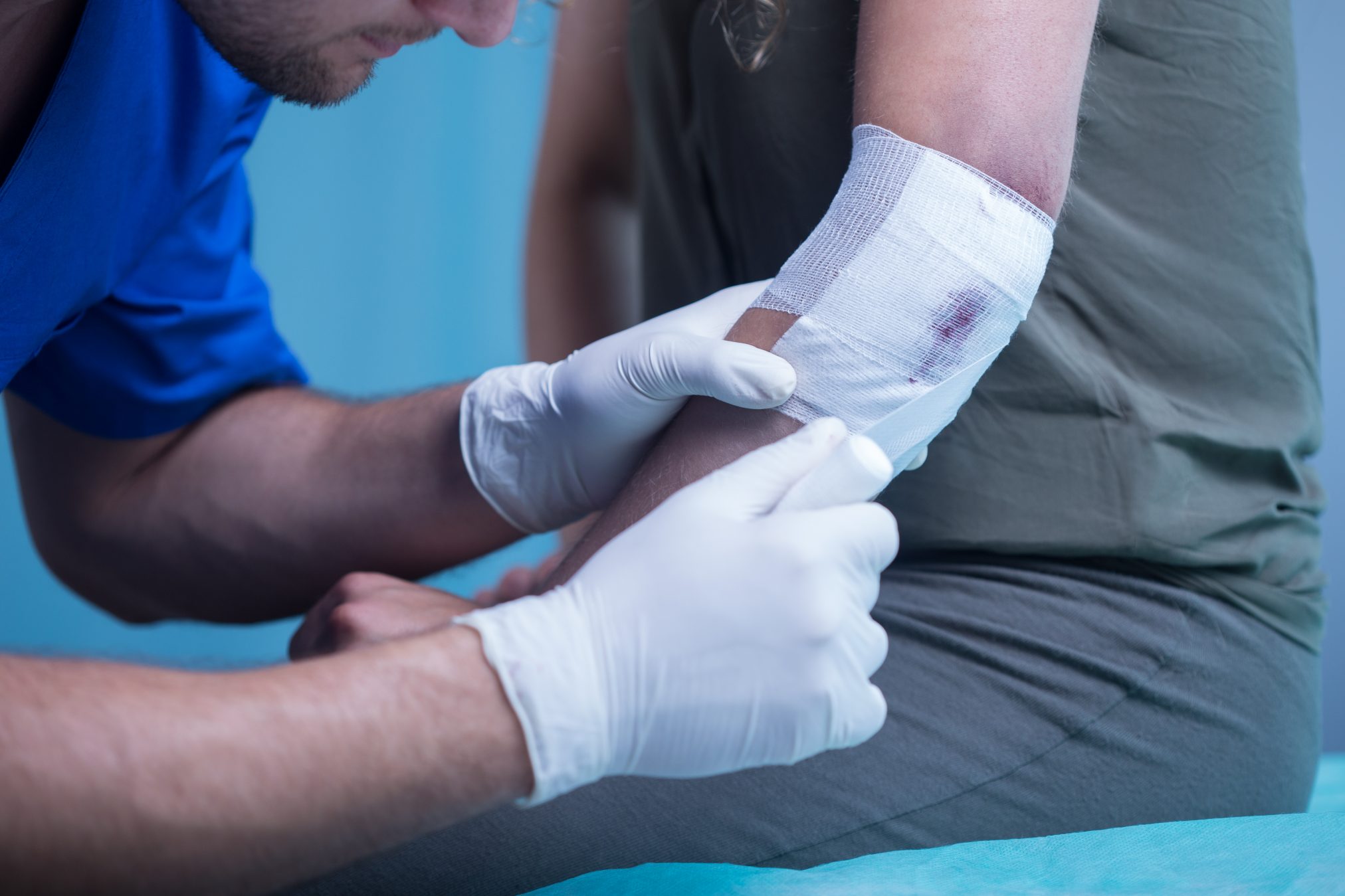 health worker bandaging an elbow