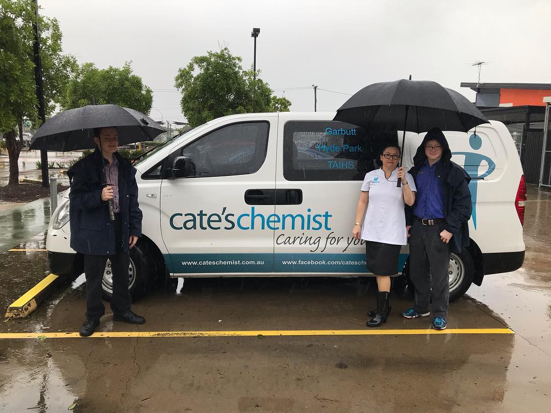 Cate's Chemist staff brave the wet to go to work. Image: Cate's Chemist via Facebook.