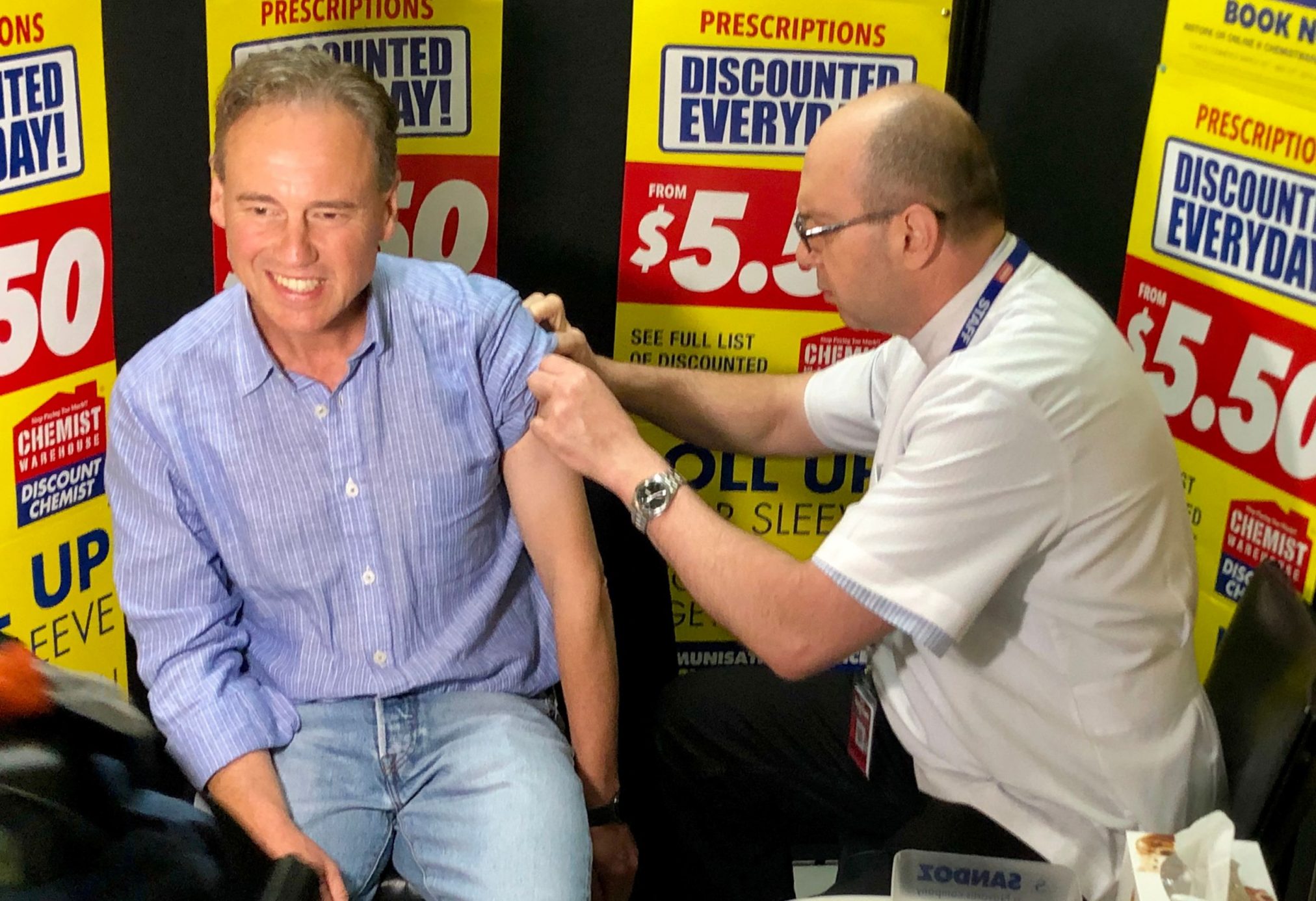 Greg Hunt receives his flu vaccine at Chemist Warehouse Mornington.