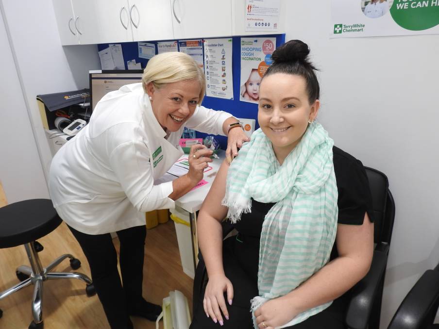 Judy Plunkett administering a flu vaccination