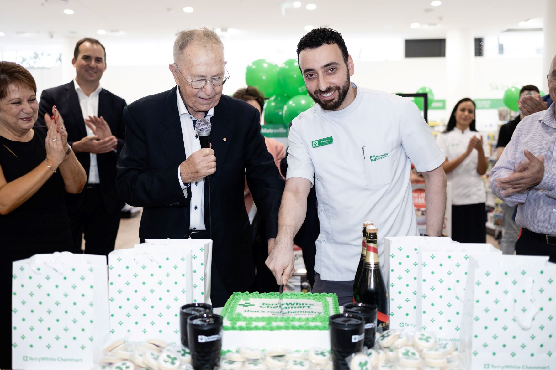 Terry White cutting the cake with TerryWhite Chemmart Matraville Managing Partner Movses Injejikian at the opening of the 500th TerryWhite Chemmart pharmacy