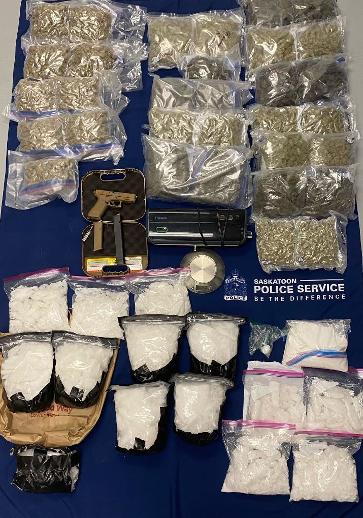 A gun, lots of cannabis in bags, lots of white pills in bags, lots of white powder in bags